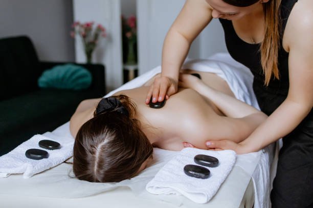 Client receiving back cupping treatment in a softly lit therapy room with calming ambiance