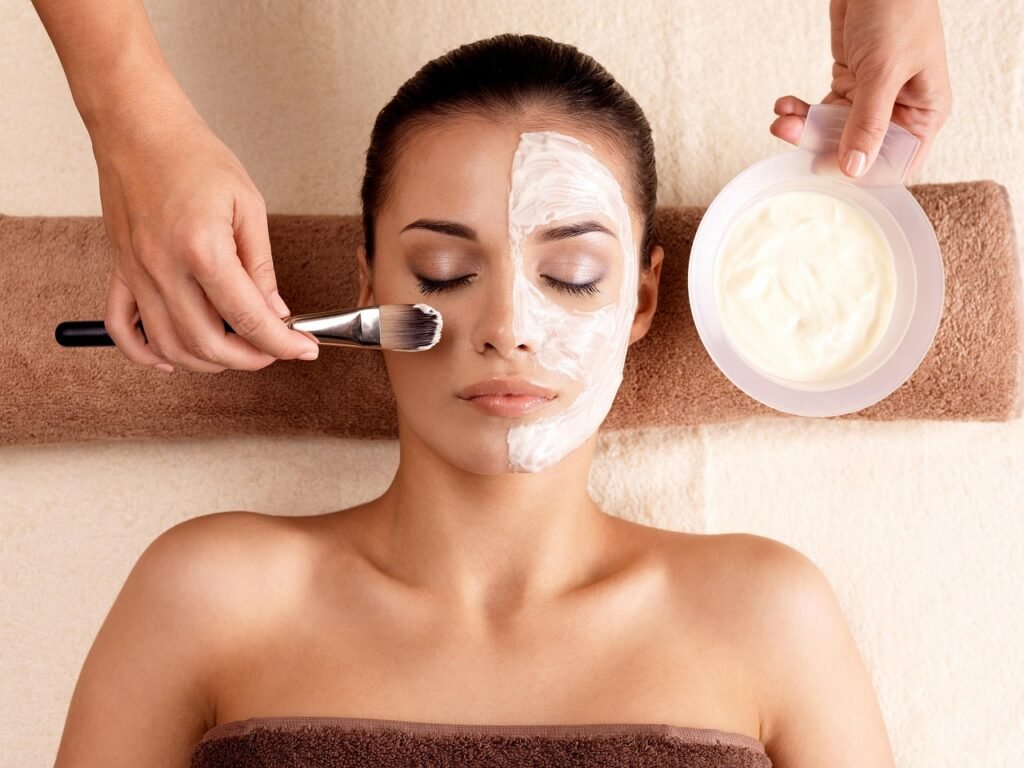Woman receiving a deep-cleansing facial with exfoliating mask applied in a serene spa environment